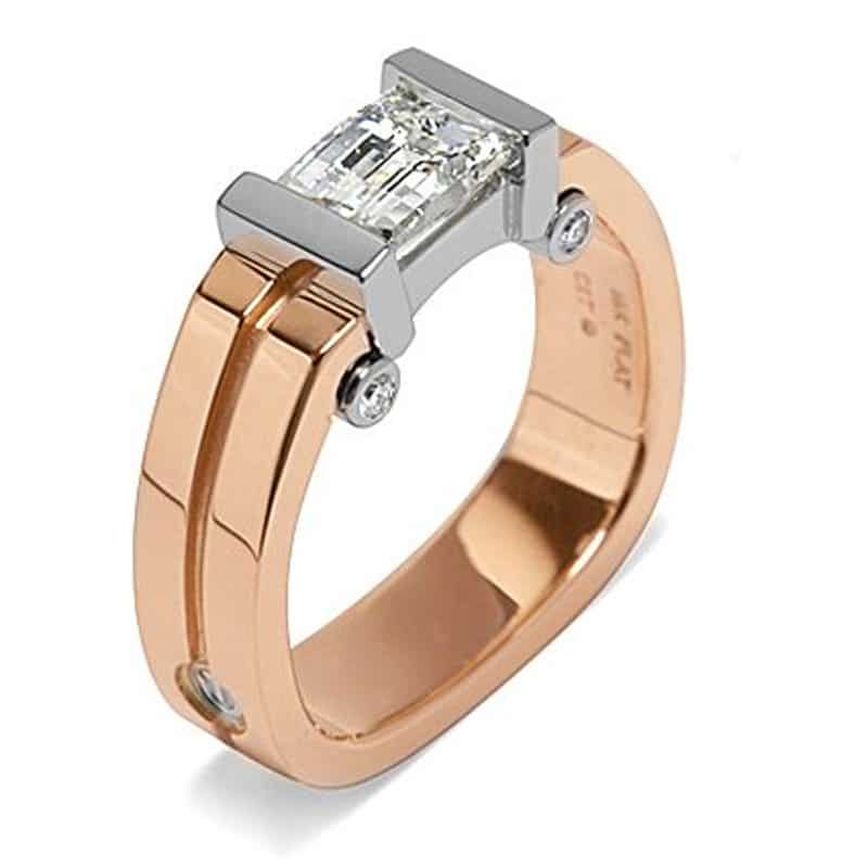Emerald cut diamond ring in rose gold and platinum setting, featuring a modern design with accent diamonds.