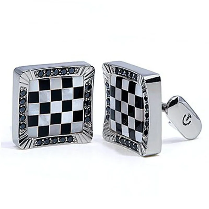 Checkerboard design white gold men's cufflinks featuring black and white mother-of-pearl inlay and blue sapphires.