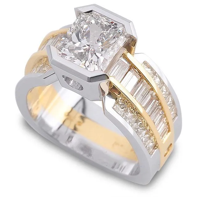 Interlude platinum three-stone diamond ring featuring a radiant cut center stone, accented by baguette and round diamonds in a two-tone gold setting.