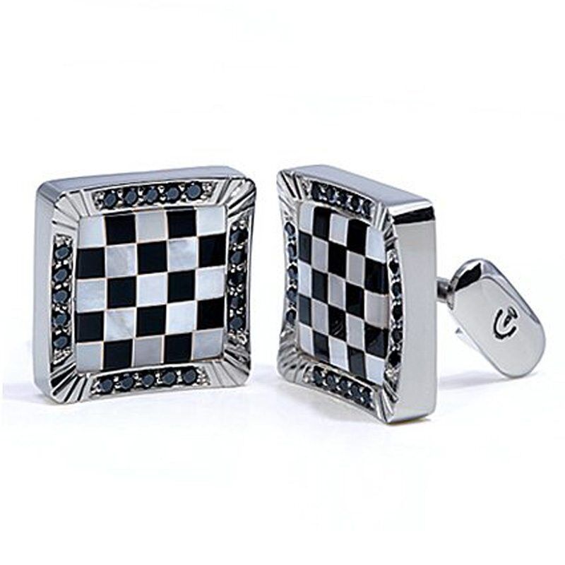 Checkerboard design white gold men's cufflinks featuring black and white mother-of-pearl inlay and blue sapphires.
