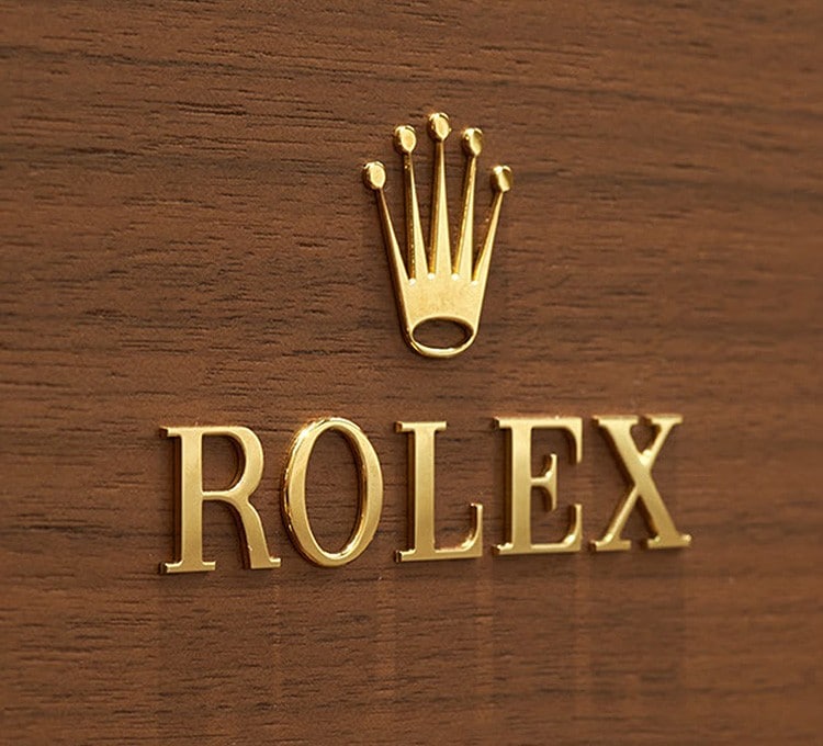 Rolex Gold Logo on wood grain